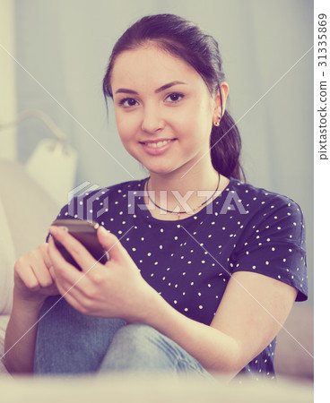 Smiling woman using smartphone Smiling woman using smartphone 31335869