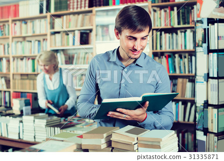 man looking at open book 31335871