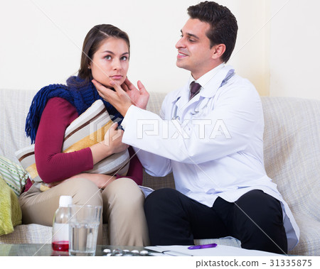 Doctor visiting female patient suffering of cold at home Doctor visiting female patient suffering of cold at home 31335875