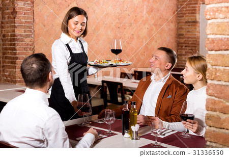 Female waiter carrying order for visitors 31336550