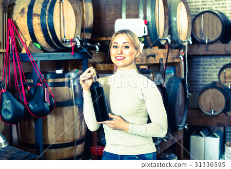Portrait of female holding wine glass in winery Portrait of female holding wine glass in winery 31336595