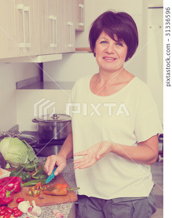 mature woman making salad mature woman making salad 31336596