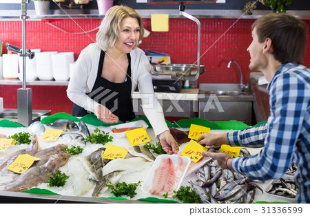 Customer buying fish in shop. Customer buying fish in shop. 31336599