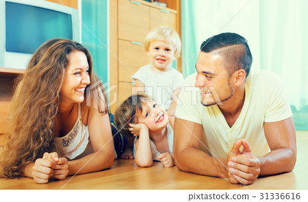 Happy family of four at home 31336616