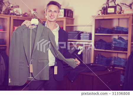 Customer examining suits 31336808