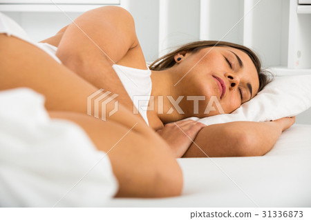 Woman sleeping in bed 31336873