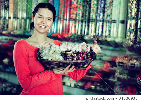 Photo of girl in the shop with lots of sweets 31336935