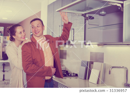 Couple looking at modern kitchen Couple looking at modern kitchen 31336957