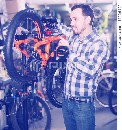 interested male mounts bicycle parts for assembly bike in shop interested male mounts bicycle parts for assembly bike in shop 31336993