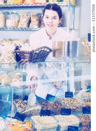 Girl offers a variety of nuts Girl offers a variety of nuts 31337008