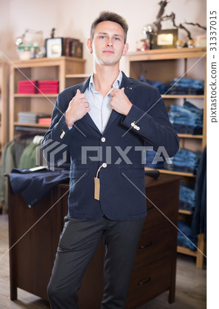 Smiling man shopper searching new suit Smiling man shopper searching new suit 31337015