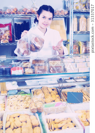 Saleswoman posing with cookies Saleswoman posing with cookies 31337017