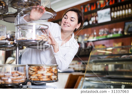 Woman choosing dessert Woman choosing dessert 31337063