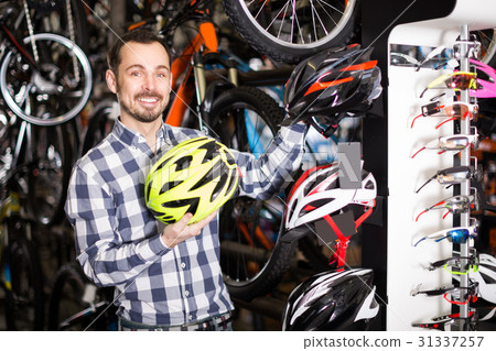 Cyclist is choosing the safest helmet 31337257