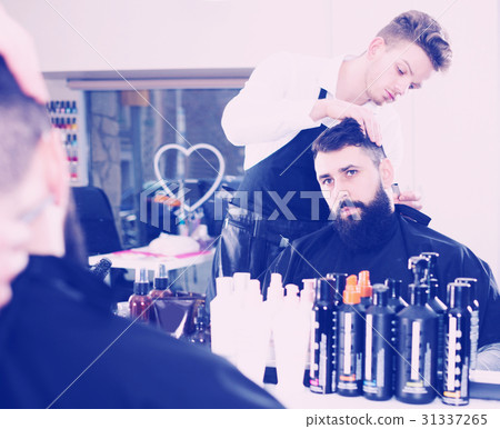 Client looking displeased about new haircut Client looking displeased about new haircut 31337265
