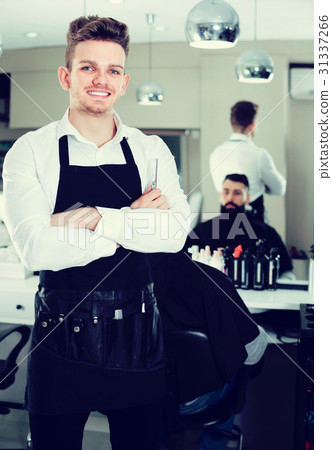 male hairdresser showing his workplace and tools at hair salon male hairdresser showing his workplace and tools at hair salon 31337266
