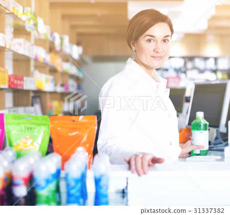 Pharmacist ready to assist in choosing at counter 31337382
