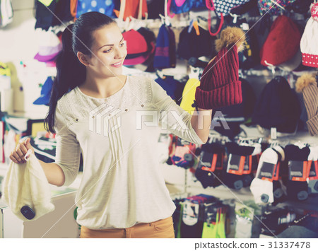Woman choosing new knit cap Woman choosing new knit cap 31337478