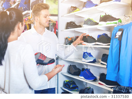 Young couple choosing new sneakers in sports store 31337580
