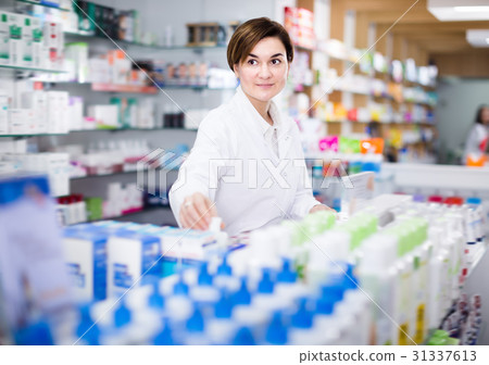 Female arranging assortment of products Female arranging assortment of products 31337613