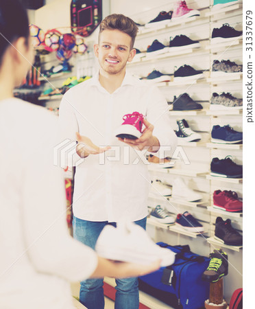 Male shop assistant helping customer Male shop assistant helping customer 31337679