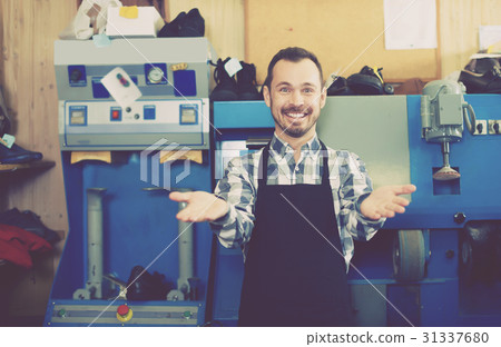 Adult worker showing his workplace and tools 31337680