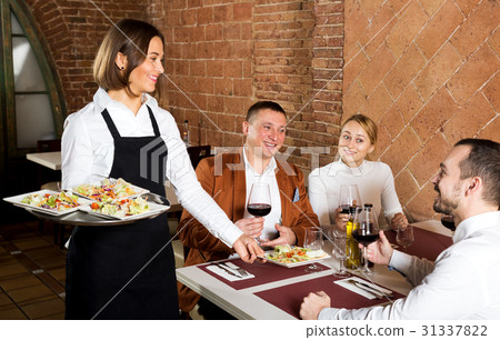 Female waiter carrying order for visitors 31337822