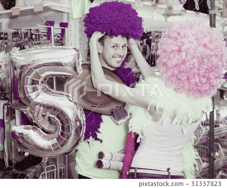 Family couple preparing for fest and choosing clown wigs 31337823