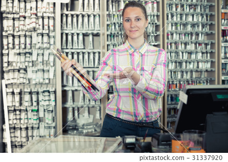 Female seller posing at counter Female seller posing at counter 31337920