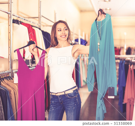 Young smiling girl trying on new gown 31338069