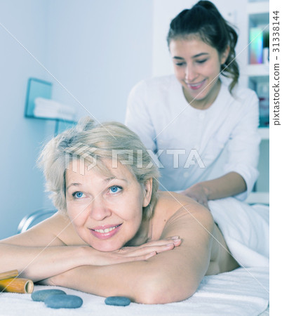 Mature woman having massage Mature woman having massage 31338144