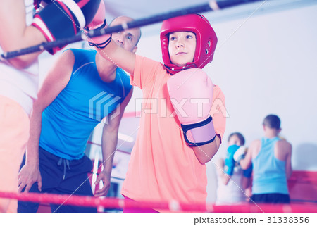 Children training on boxing ring 31338356