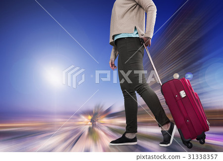 Woman with suitcase awaiting aircraft 31338357