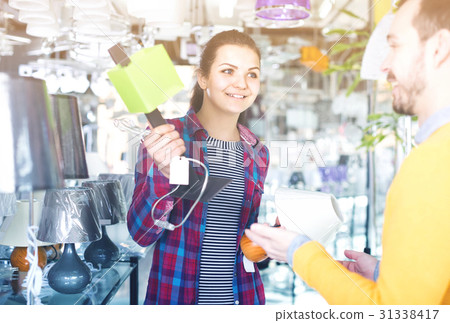 man and girl in lighter shop choosing stylish and modern lamp for house interior 31338417
