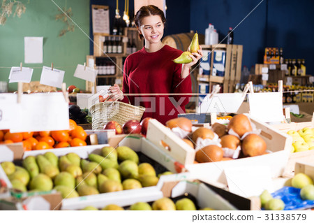 Girl buying ripe pineapple 31338579