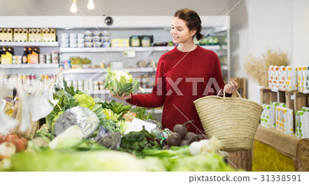 happy young girl buying cauliflower at market happy young girl buying cauliflower at market 31338591