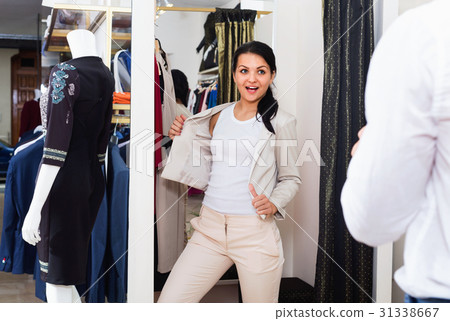 Couple choosing jacket and dress at boutique Couple choosing jacket and dress at boutique 31338667