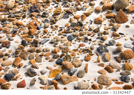smooth round pebble stones on the sand backgound. smooth round pebble stones on the sand backgound. 31342447