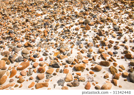 smooth round pebble stones on the sand backgound. smooth round pebble stones on the sand backgound. 31342448