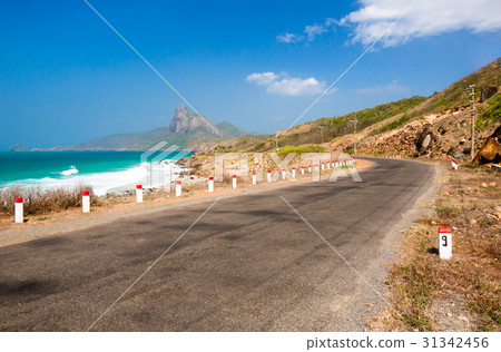 Road along the turquoise sea Bainhat beach Condao. 31342456