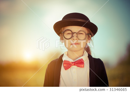 Funny little girl in bow tie and bowler hat. Funny little girl in bow tie and bowler hat. 31346085