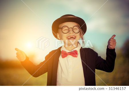 Funny little girl in bow tie and bowler hat 31346157