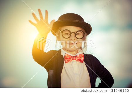 Funny little girl in bow tie and bowler hat with 31346160