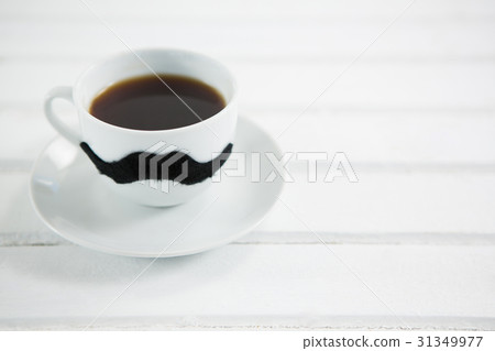 Coffee cup with mustache on white table Coffee cup with mustache on white table 31349977