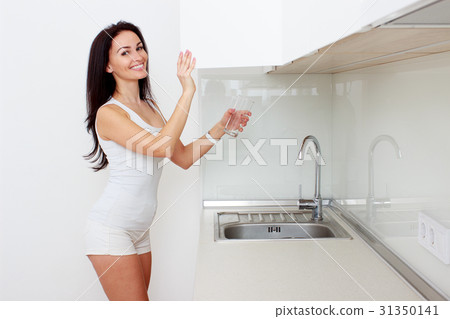 Young woman in the kitchen Young woman in the kitchen 31350141