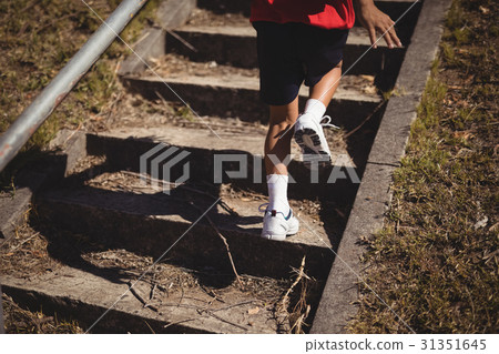 Low section of girl running upstairs during course Low section of girl running upstairs during course 31351645