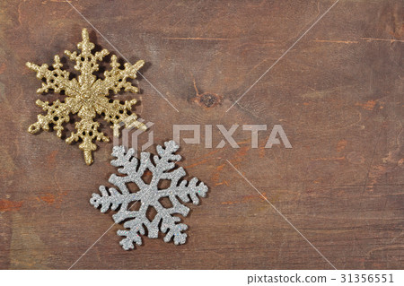 Two snowflakes on a wooden background Two snowflakes on a wooden background 31356551