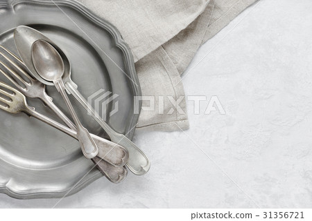 Silverware on a pewter plate 31356721