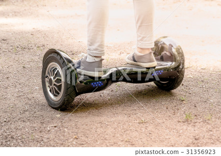 Girl feet on the hover board. 31356923