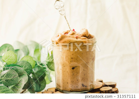 Melts ice cream with raspberries in a glass jar. Melts ice cream with raspberries in a glass jar. 31357111